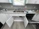 Double kitchen sink with new white cabinets and granite countertops at 1170 S Central Ave, Apopka, FL 32703