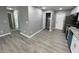Modern kitchen with grey walls, wood-look floors, and white cabinets at 1170 S Central Ave, Apopka, FL 32703