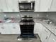 Modern kitchen features stainless steel appliances and granite countertops at 1170 S Central Ave, Apopka, FL 32703
