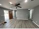 Bright living room with gray walls, vinyl flooring, and ceiling fan at 1170 S Central Ave, Apopka, FL 32703