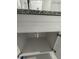 White vanity with granite countertop and empty cabinet below at 1170 S Central Ave, Apopka, FL 32703