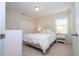 Bright bedroom with white bedding, a metal bed frame, and carpeted floors at 12109 Silverlake Park Dr, Windermere, FL 34786