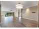 Bright living room featuring hardwood floors and a stunning chandelier at 1309 Fortaleza Dr, The Villages, FL 32162