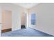 Spacious bedroom with blue carpet, walk-in closet, and additional door at 14272 Southern Red Maple Dr, Orlando, FL 32828