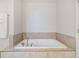 Clean bathroom with a soaking tub and tile surround at 159 Golden Noble St, Kissimmee, FL 34747