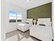 Bedroom with two twin beds and green accent wall at 159 Golden Noble St, Kissimmee, FL 34747