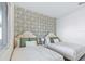 Twin bedroom with green accent wall and window at 159 Golden Noble St, Kissimmee, FL 34747