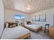 Bedroom with two twin-size beds and patterned ceiling at 159 Golden Noble St, Kissimmee, FL 34747