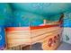 Unique boat-shaped bunk bed in a nautical-themed bedroom at 159 Golden Noble St, Kissimmee, FL 34747