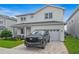 Two-story house with white exterior, gray roof, and a black SUV parked in the driveway at 159 Golden Noble St, Kissimmee, FL 34747