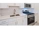 Modern kitchen with white cabinets and gas range at 159 Golden Noble St, Kissimmee, FL 34747