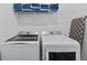 Clean laundry room featuring a washer, dryer, and storage at 159 Golden Noble St, Kissimmee, FL 34747