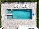 Overhead view of refreshing pool, spa, and lounge chairs at 159 Golden Noble St, Kissimmee, FL 34747
