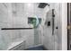 Modern bathroom with walk-in shower and marble tile at 1812 Hudson Ct, Kissimmee, FL 34759