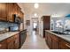 Modern kitchen with granite countertops and dark wood cabinets at 1812 Hudson Ct, Kissimmee, FL 34759