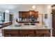 Kitchen island with granite countertop and dark wood cabinets at 1812 Hudson Ct, Kissimmee, FL 34759