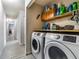 Laundry room with washer, dryer, and storage shelves at 1812 Hudson Ct, Kissimmee, FL 34759