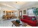 Living room features red couch, wooden coffee table, and dining area at 1812 Hudson Ct, Kissimmee, FL 34759