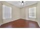 Bright bedroom with hardwood floors and two windows at 1913 Cedar Arch Ln, Orlando, FL 32824