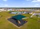 Community playground and pool with surrounding homes under a blue sky at 2665 Magnolia Ave, Davenport, FL 33837