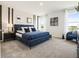 Spacious main bedroom with large window and blue bedding at 2729 Golden Trout Ln, Edgewater, FL 32141