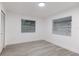 Spacious bedroom with gray vinyl flooring and two windows with blinds at 3149 W Washington St, Orlando, FL 32805
