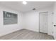 Bright bedroom with window, closet, and grey vinyl flooring at 3149 W Washington St, Orlando, FL 32805