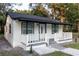 Updated home exterior boasts a fresh white coat of paint, black accents, and a covered porch at 3149 W Washington St, Orlando, FL 32805