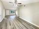 Spacious living area with wood-look floors and ceiling fan at 317 Florida Pkwy, Kissimmee, FL 34743