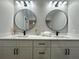 Modern bathroom with double vanity, quartz countertop, and large mirrors at 3522 E Kaley Ave, Orlando, FL 32806