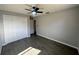 Spacious bedroom with ceiling fan, double-door closet, and tile flooring at 3522 E Kaley Ave, Orlando, FL 32806