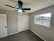 Spacious bedroom with ceiling fan, double-door closet, and tile flooring at 3522 E Kaley Ave, Orlando, FL 32806