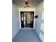 Modern entryway with black double doors and a stylish light fixture at 3522 E Kaley Ave, Orlando, FL 32806