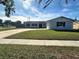 Newly renovated home with a large yard and updated landscaping at 3522 E Kaley Ave, Orlando, FL 32806