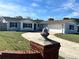 Newly renovated home with a large driveway and brick pillars at 3522 E Kaley Ave, Orlando, FL 32806