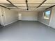 Spacious garage with painted floor and overhead door at 3522 E Kaley Ave, Orlando, FL 32806