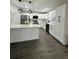 Modern kitchen with white cabinets, stainless steel appliances, and a large island at 3522 E Kaley Ave, Orlando, FL 32806
