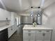 Modern kitchen with white cabinets, quartz countertops, and a large island at 3522 E Kaley Ave, Orlando, FL 32806
