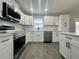 Modern kitchen with white shaker cabinets and stainless steel appliances at 3522 E Kaley Ave, Orlando, FL 32806