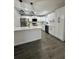 Modern kitchen with white cabinets, stainless steel appliances, and a large island at 3522 E Kaley Ave, Orlando, FL 32806