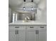 Modern kitchen with white cabinets, stainless steel appliances, and quartz countertops at 3522 E Kaley Ave, Orlando, FL 32806