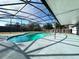 Relaxing kidney-shaped pool with screened enclosure at 3522 E Kaley Ave, Orlando, FL 32806