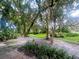 Lush green backyard with mature trees and landscaping at 423 Sheoah Blvd # 19, Winter Springs, FL 32708