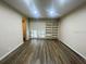 Living area with built-in shelving and wood-look flooring at 423 Sheoah Blvd # 19, Winter Springs, FL 32708