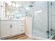 Bright bathroom featuring a walk-in shower and white cabinets at 459 Lanarkshire Pl, Apopka, FL 32712