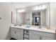 Double vanity bathroom with modern finishes and a large mirror at 4721 Clock Tower Dr # 204, Kissimmee, FL 34746