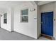 Private condo entry with blue door and welcome mat at 4721 Clock Tower Dr # 204, Kissimmee, FL 34746