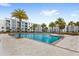 Resort-style pool with lounge chairs and palm trees at 4721 Clock Tower Dr # 204, Kissimmee, FL 34746