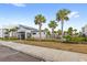 Community pool with palm trees and cabana at 4721 Clock Tower Dr # 204, Kissimmee, FL 34746