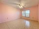 Spacious bedroom with light pink walls and tile flooring at 505 Polaris Loop # 107, Casselberry, FL 32707